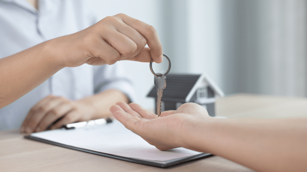 A person handing a key to another person