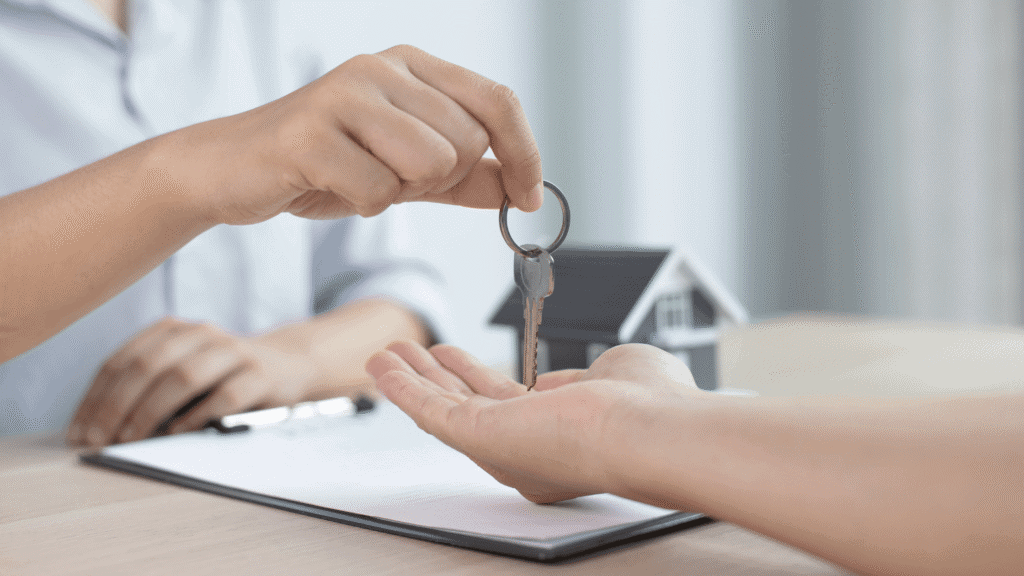 A person handing a key to another person