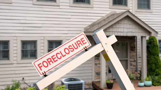 A house with a foreclosure sign in front of it