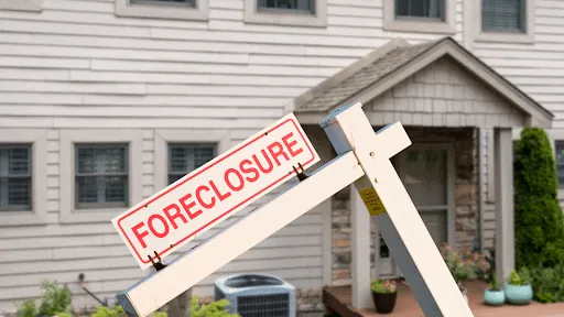 A house with a foreclosure sign in front of it